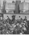 An old black and white photo of a crowded ship.