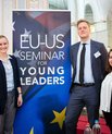 Lisa Lechner, Lars Svensmark and Miriam Karout stand in front of a pull up banner that says: EU-US Seminar for Young Leaders