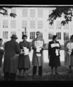 Picture showing five people standing on a line, each of them carrying a sign for one of the Norwegian political parties.